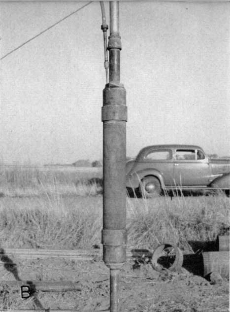 Black and white photo; pneumatic packer is perhaps three feet high; in background is old sedan (1940s?, probably not old when photo was taken).