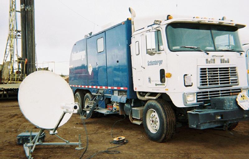Color photo of front of a modern logging truck.