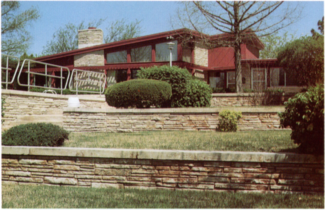 Color photo of a good example of limestone use for landscaping, as well as the residence.