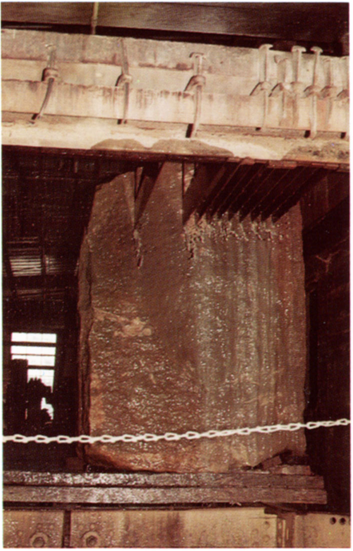 Color photo of a gang saw cuts quarry blocks into large slabs.