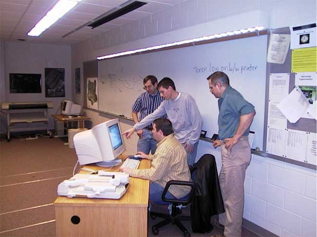 Team members in classroom working at GIS workstation