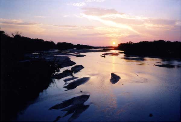 Photo of sunset over slow river.