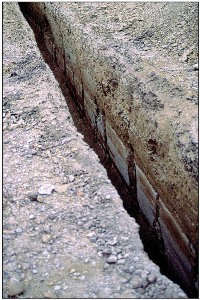 Color photo looking into trench from side shows joints in limestone.