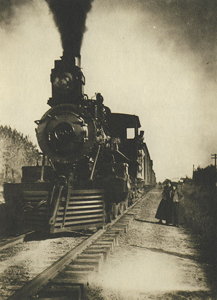 Sepia photo of coal-burning steam locomotive.